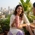Lifestyle scene with a woman holding a pink tumbler at a rooftop café with a friend